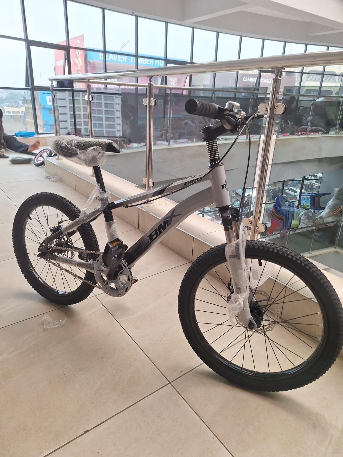 20 inch grey BMX bicycle with front suspension and dual disc brakes