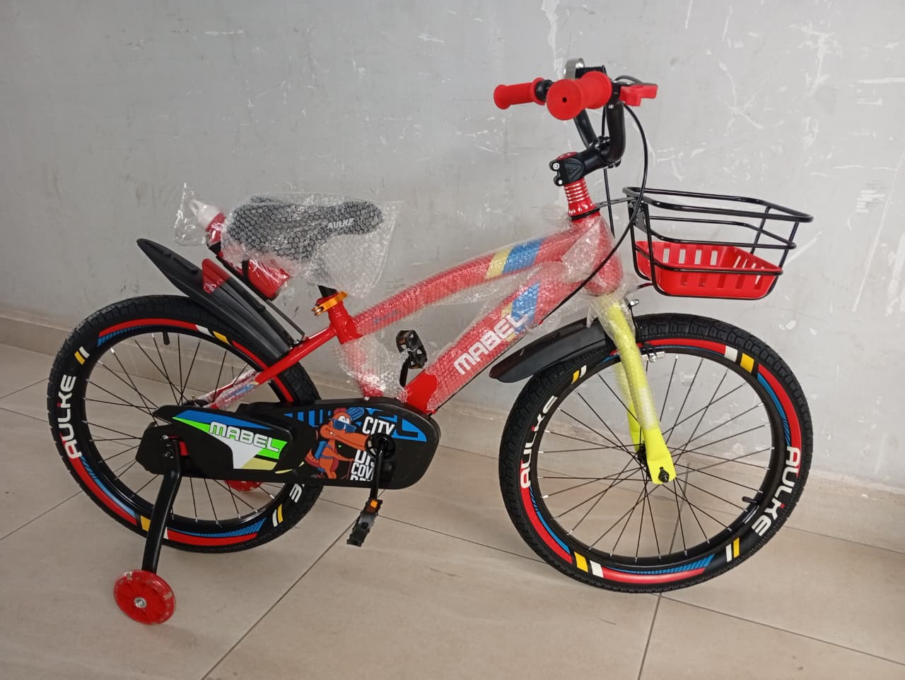 Mabel Size 20 kids bicycle with front basket, removable training wheels, rear carrier, and mudguards.