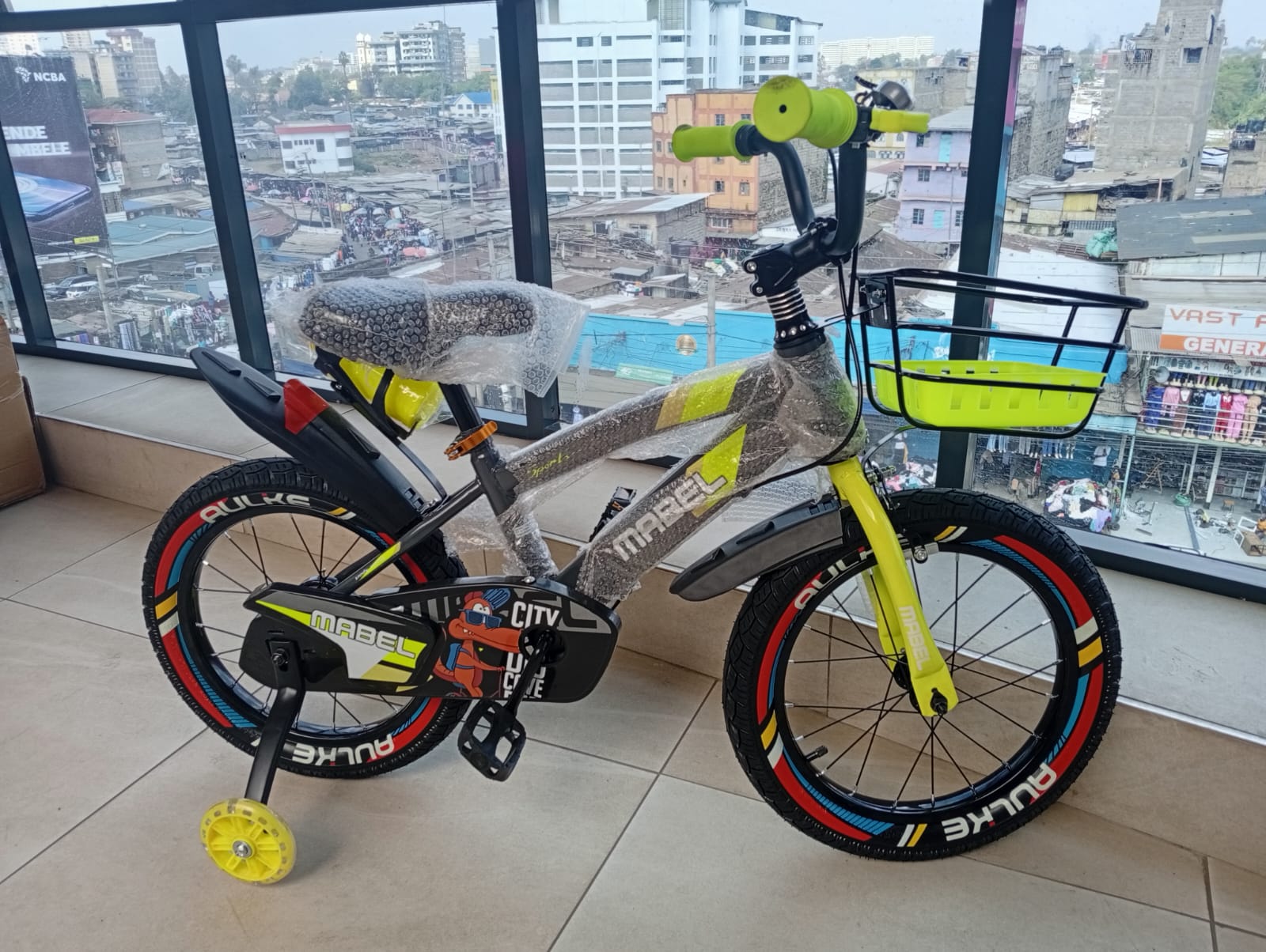 Mabel Size 16 kids bicycle featuring training wheels, front basket, rear carrier, and mudguards.