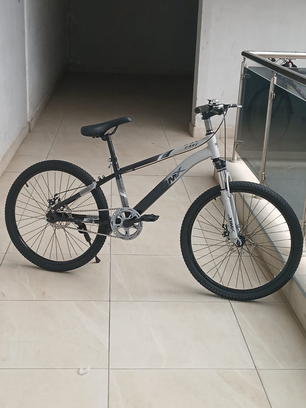 BMX Size 24 mountain bicycle with front suspension, disc brakes, and all-terrain tires.